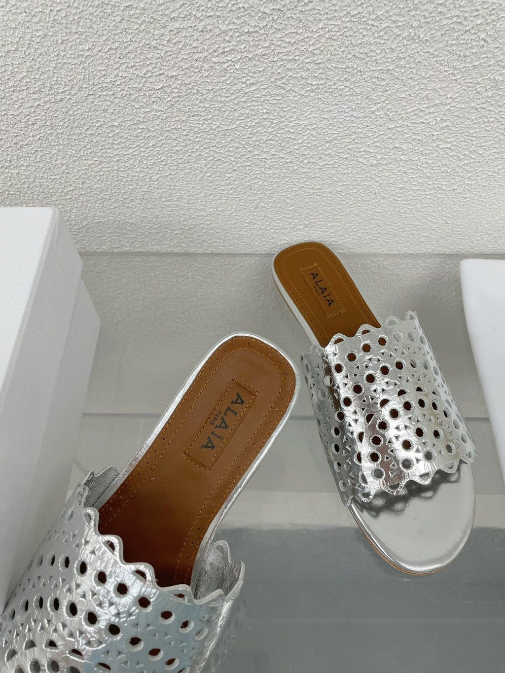 ALAIA VIENNE FLAT MULES IN SILVER LAMBSKIN